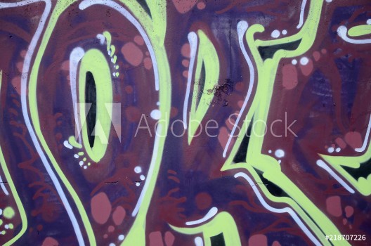 Bild på Fragment of graffiti drawings The old wall decorated with paint stains in the style of street art culture Colored background texture